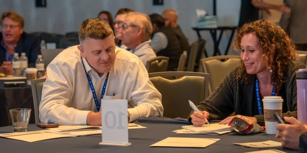 Attendees working together at a Vein Practice Growth Summit session